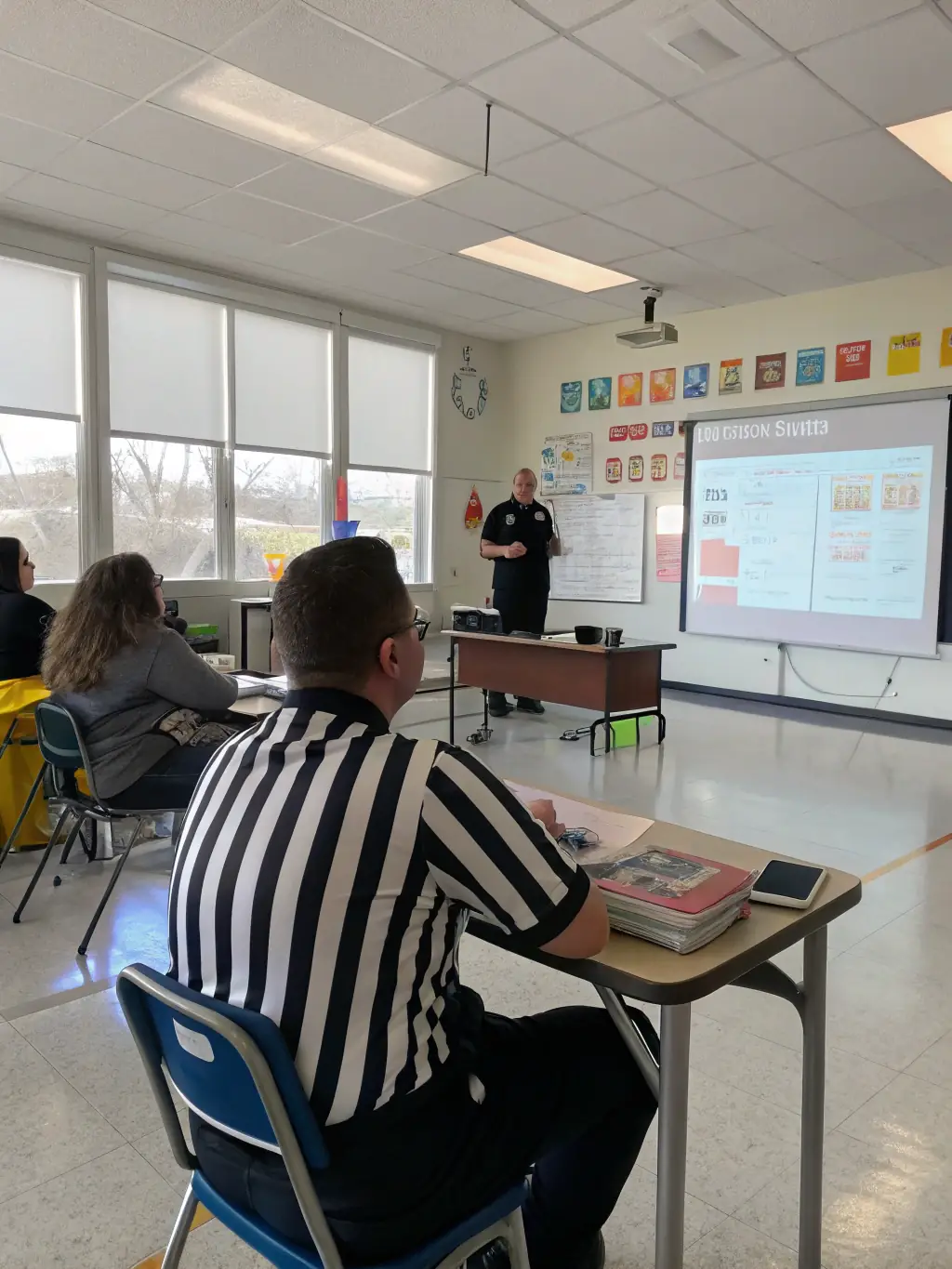 A diverse group of referees participating in a violence prevention seminar, learning techniques to manage conflicts and ensure safety.